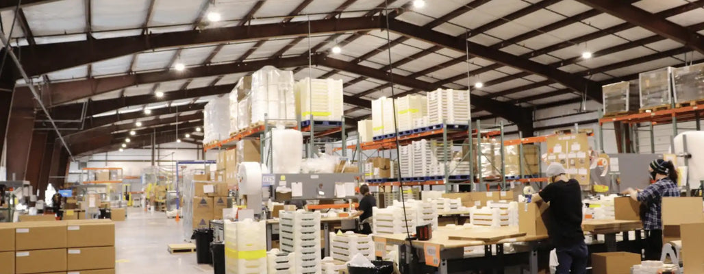 custom natural soap manufacturing facility with production team packaging and scaling handcrafted soap products